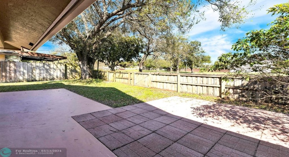 Pavered backyard with fence