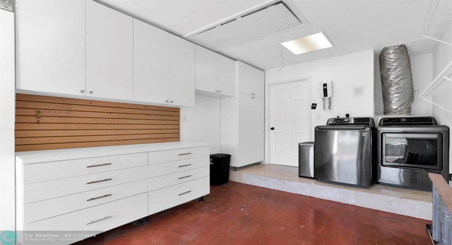 Built in cabinets for extra storage & wall slat board for organization