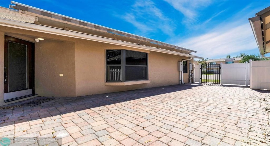 Side area w/ pavers, lighting , gas pipe hookups & retractable awning for your outdoor living
