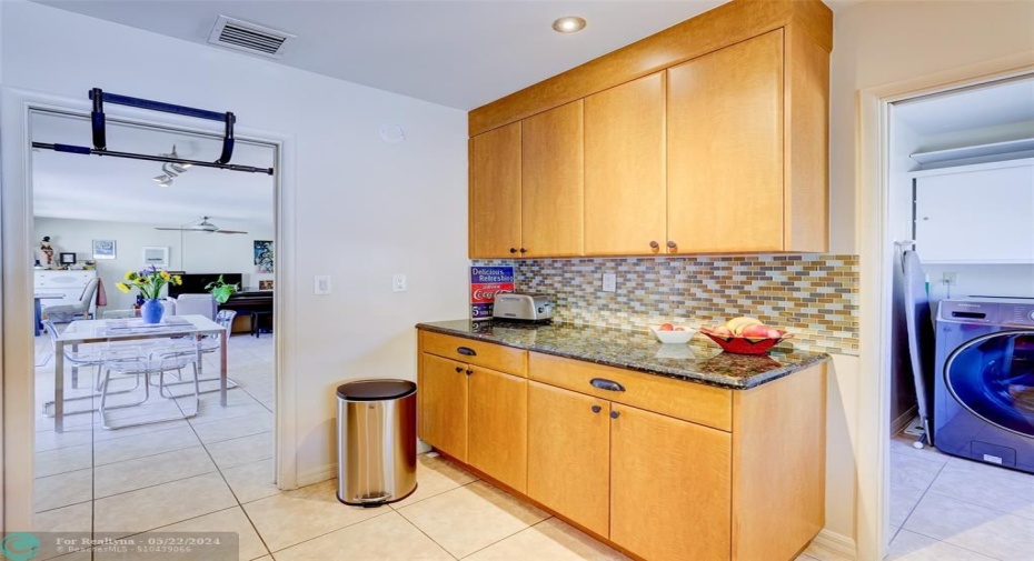 Inside laundry room conveniently located just off the kitchen.