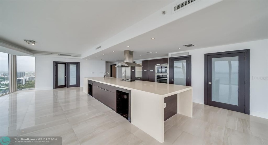 Seating at the Island - French doors lead to guest bedroom