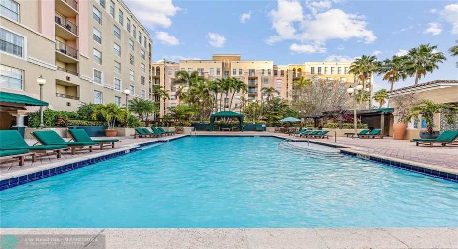 Beautiful pool with multiple relaxation spaces including some covered shaded areas with plenty of seating