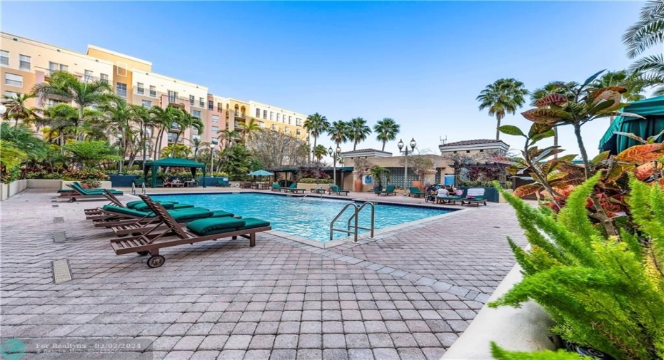 Beautiful pool with multiple relaxation spaces including some covered shaded areas with plenty of seating