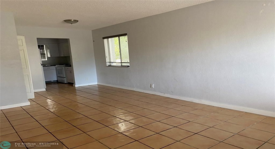 nice dining and living room with a nice side window for light and bright