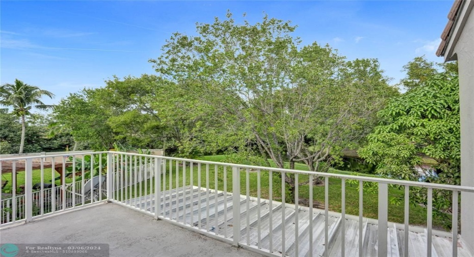 balcony off of bonus room overlooking backyard and water view!