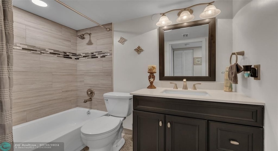 New bathroom with ceramic tile and tub.
