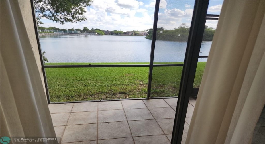 View from Living room to lake & screened in porch