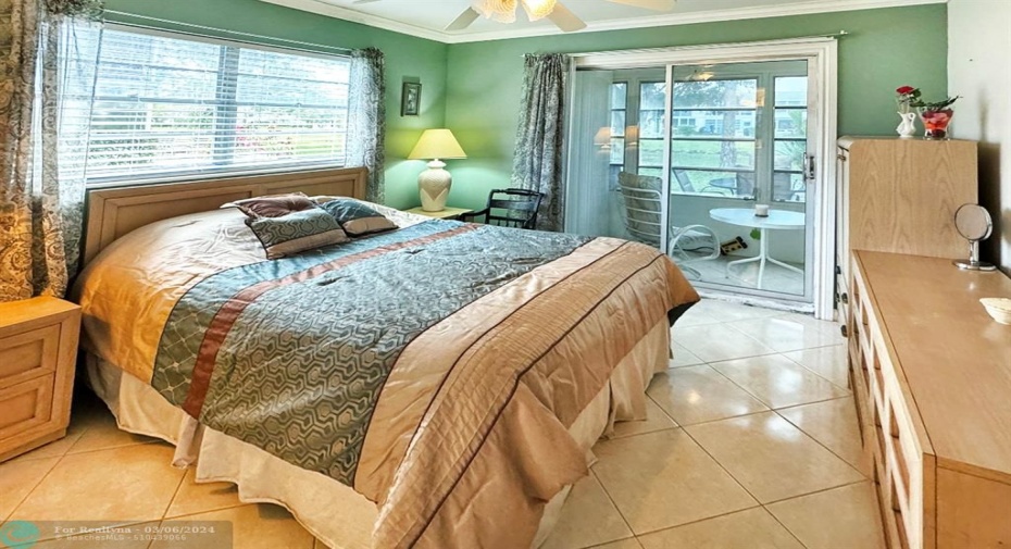 Bright Primary Bedroom w/Outside Windows & Sliders to Patio.