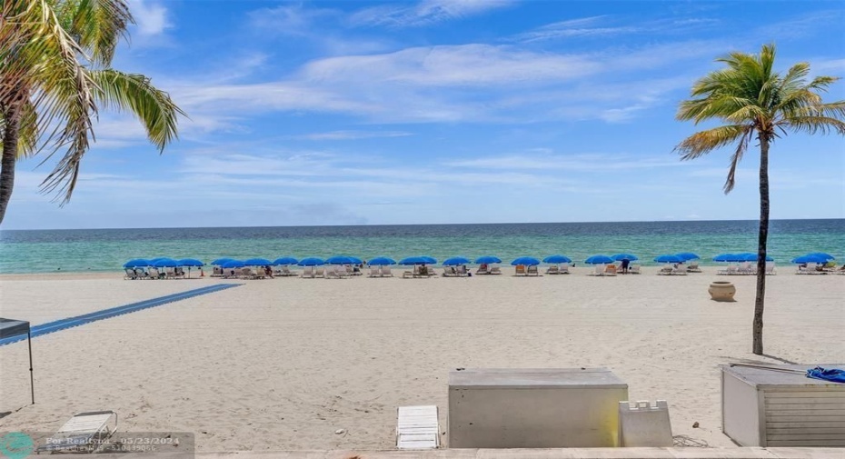 Private ocean front with lounge chairs and umbrellas