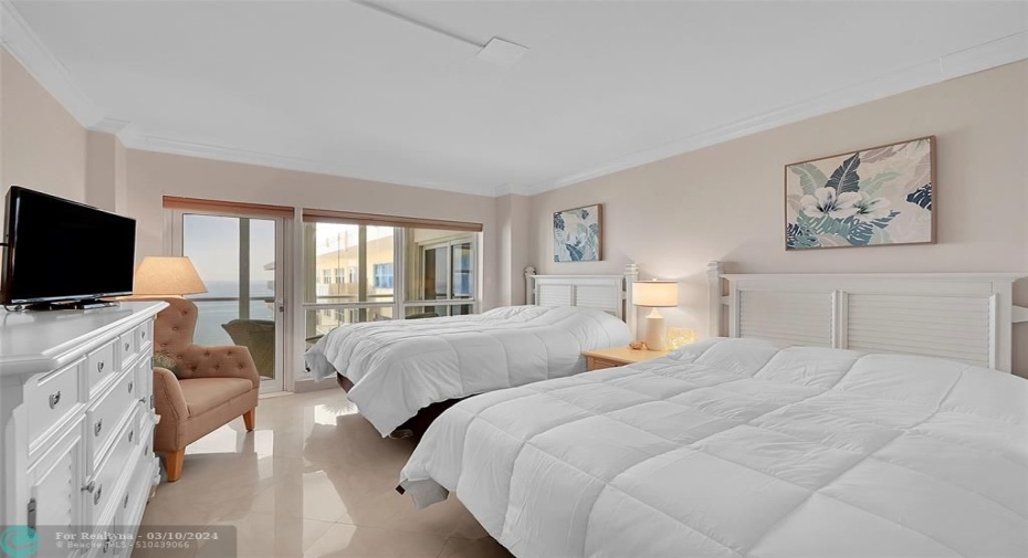 2nd bedroom with floor-to-ceiling windows and direct balcony access