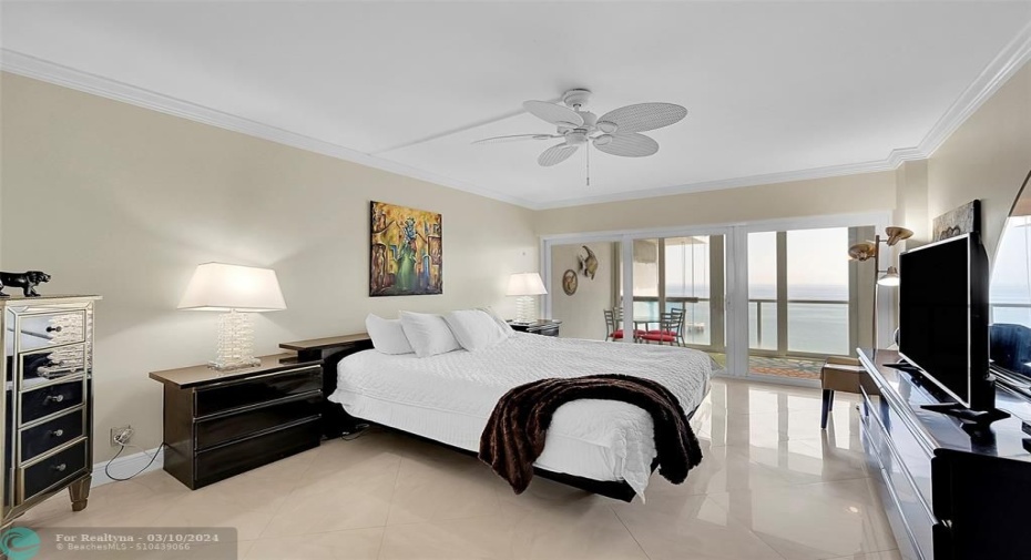 Primary bedroom with en-suite bathroom, floor to ceiling windows and direct balcony access