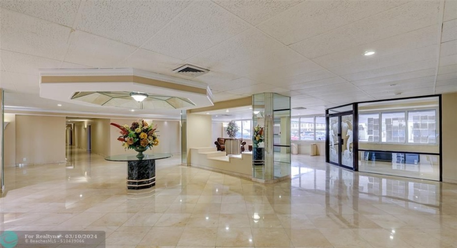 Elegant lobby with multiple sitting and conversation areas and piano