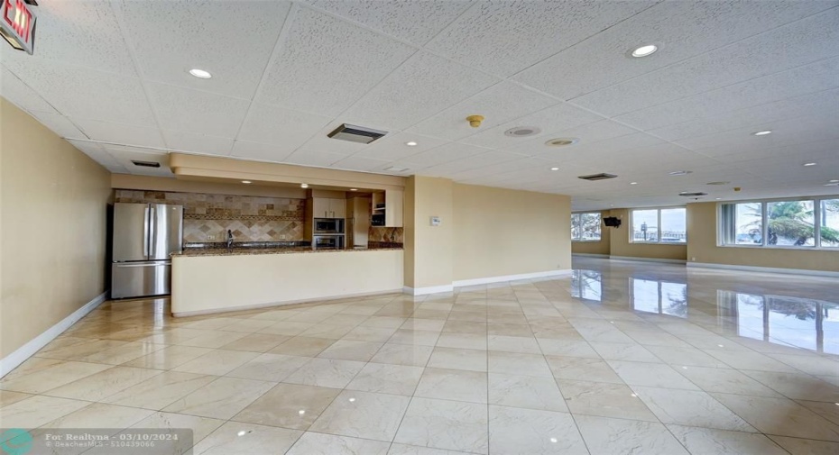 Community room offers full catering kitchen, cushioned chairs and large round tables for large soirees up to 100+ people