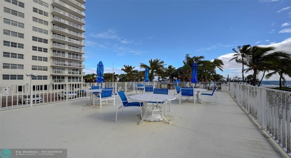 Raised BBQ Deck with grills, tables, chairs and umbrellas