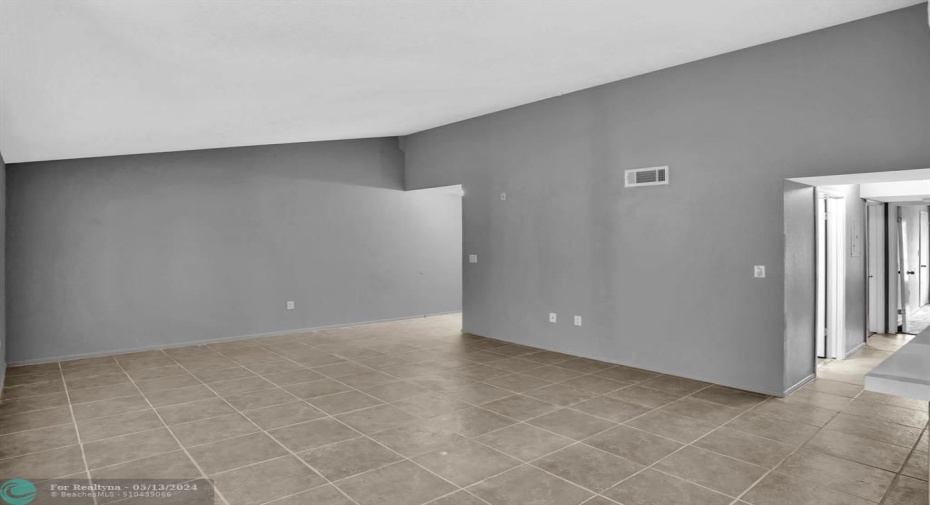 View of the Foyer entrance on left and Hallway to the Bedrooms on the right