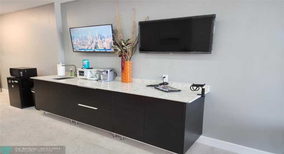 bar area for client beverages. two smart tv's