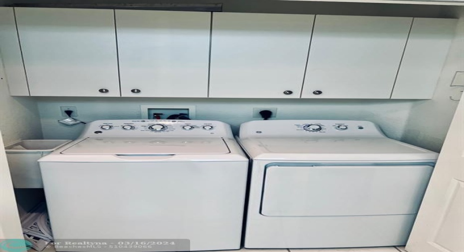 Washer and dryer with top cabinets