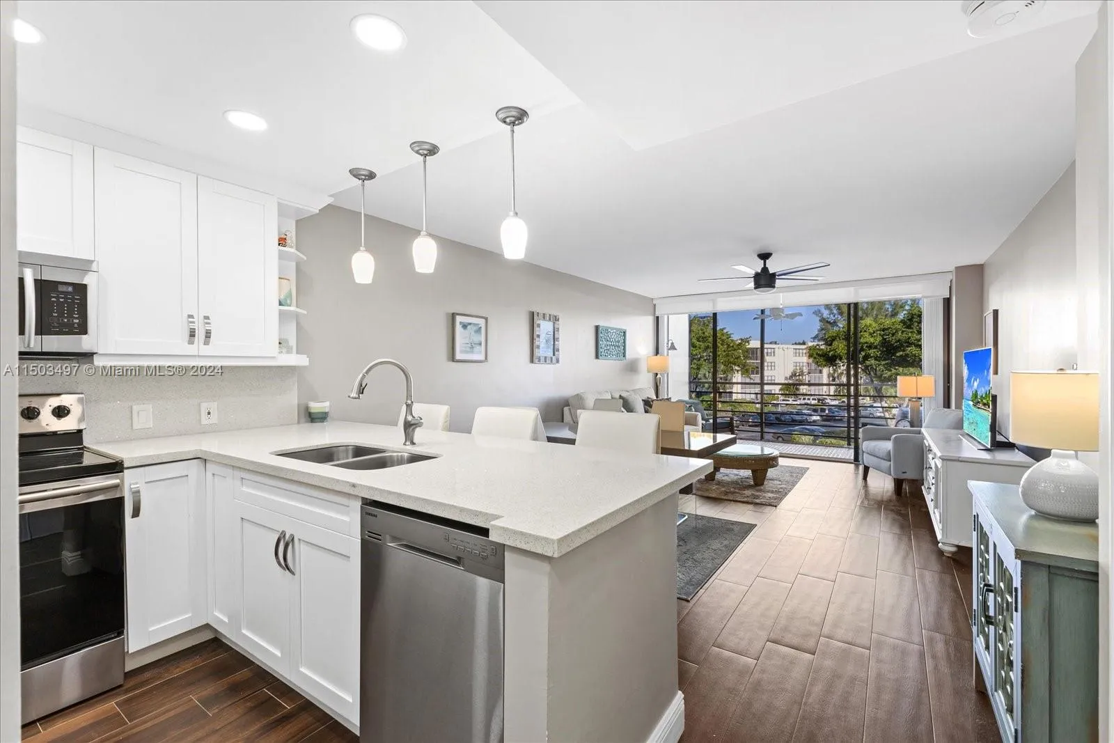 Kitchen, Living- and Dining Room. Updated floors, renovated kitchen and tastefully decorated.
Biscaya Condominium. Unit #316 is for sale.  20400 W Country Club Drive, Aventura, FL.