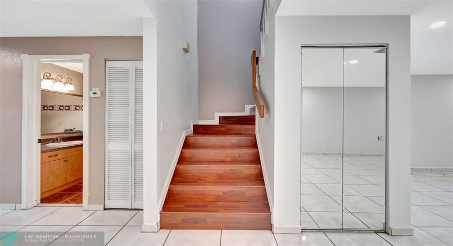 staircase and 1/2 bath to left