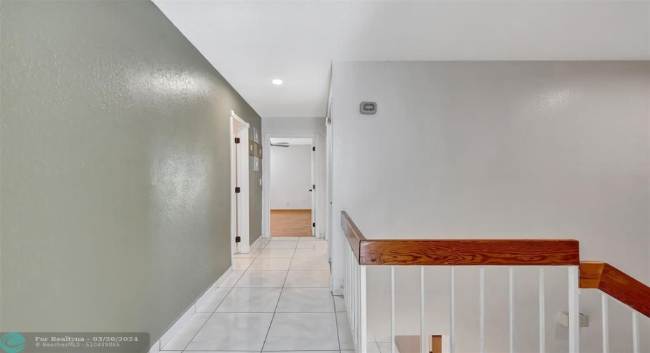 Tiled hallway to bedrooms