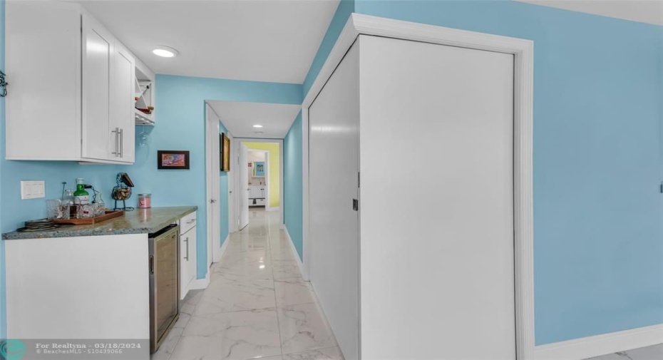 Long hallway to master suite. 2nd bedroom/office door closed