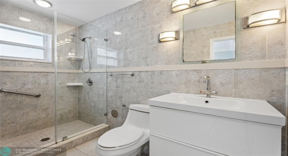 All tiled with large step in shower-glass door