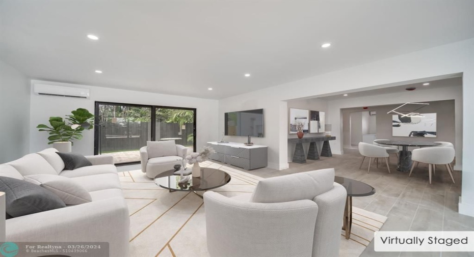 Virtually staged living/dining in larger unit.