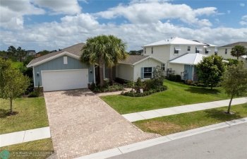one story single family home with paver driveway