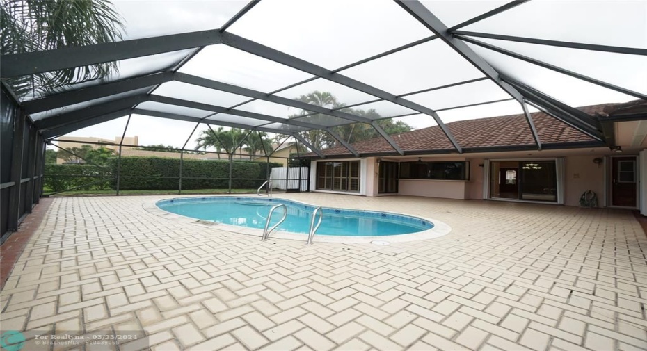 Tropical style screened in pool area.