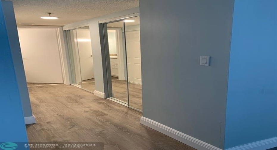 Full length mirrored closet doors on the right side.