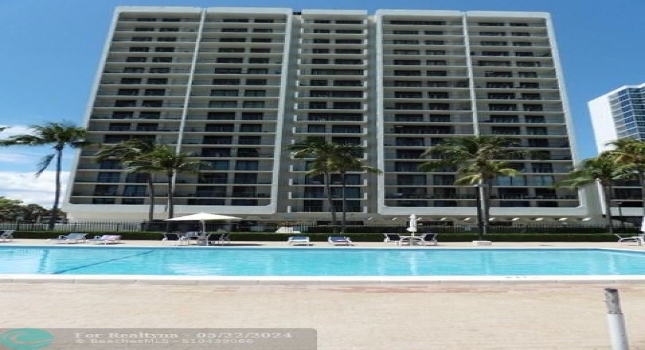 Poolside with building in background.