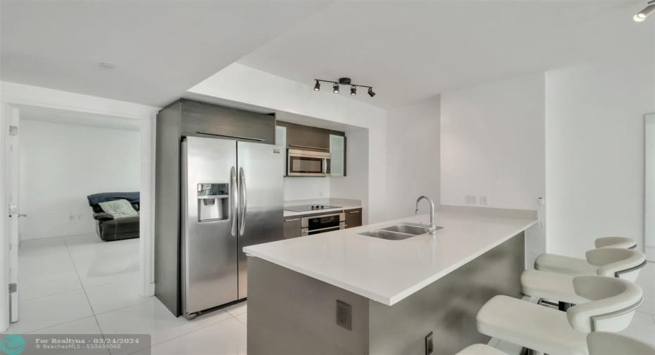 This kitchen featuresstainless steel appliances,Italian cabinets and quartzcountertop.