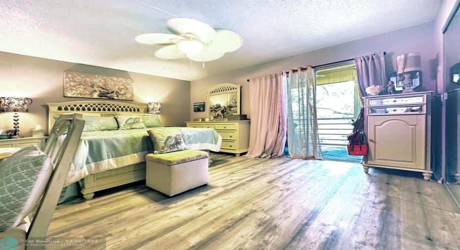 Laminate Floor Flow Thru Bedroom to Patio Area