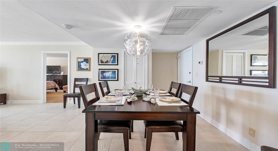 Dining room with closet and door to primary