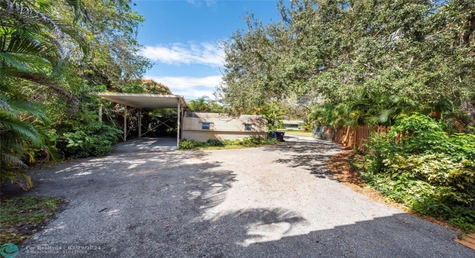 Large Carport and LARGE Shed with Electric next to private gated back entryway. ample parking
