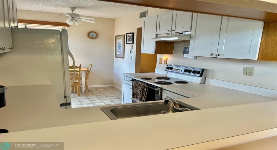 Kitchen boast plenty of storage and counter space and an eat in area.