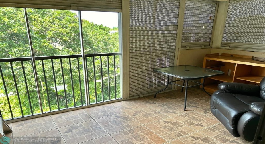 Nice sized screened patio with roll down shutter.