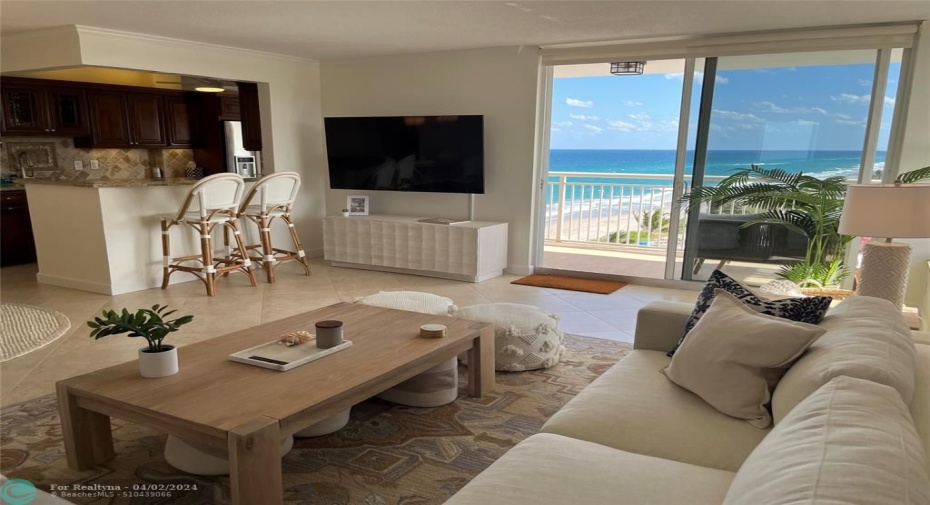 Living room with kitchen in left background