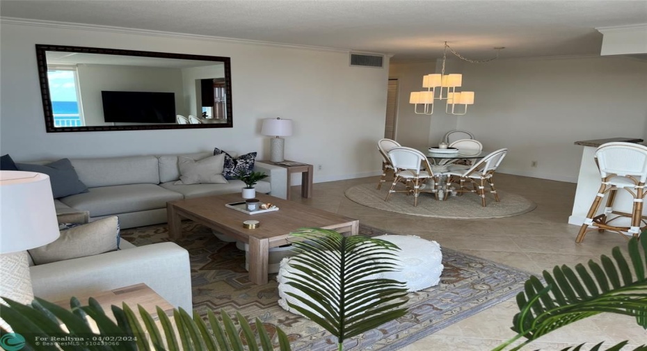 Livingroom POV to entry hall at upper left with balcony slider behind camera