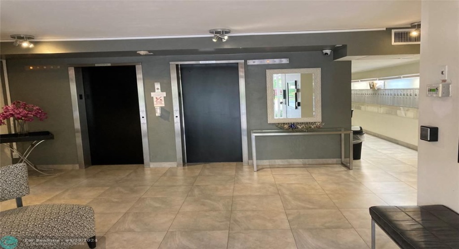 The lobby is equipped with two elevators for added convenience.