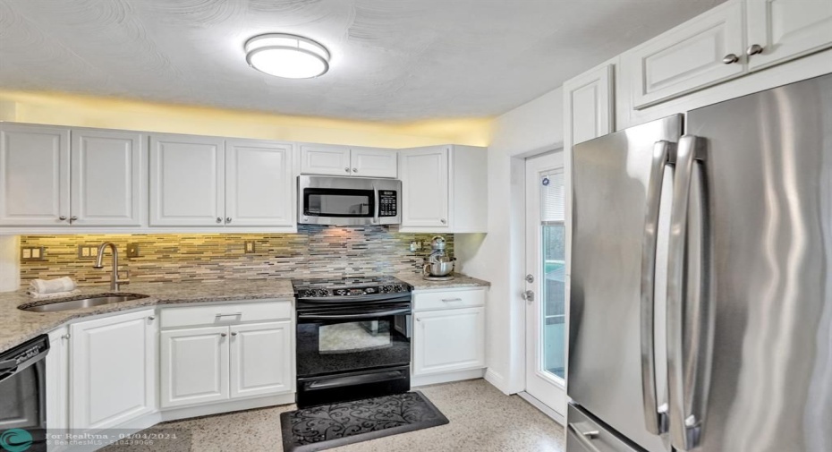 Kitchen with back patio door.