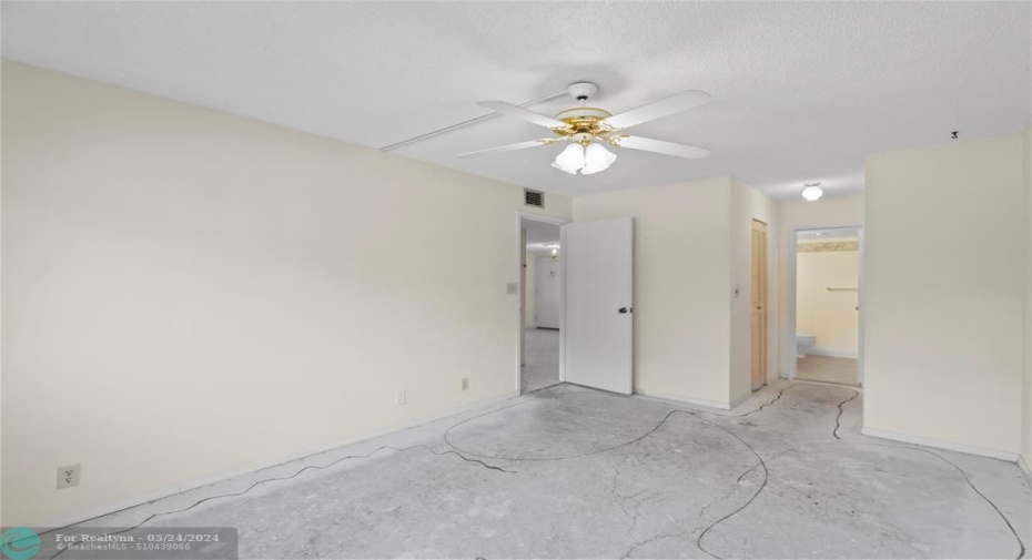 Primary bedroom looking into closet and bath area
