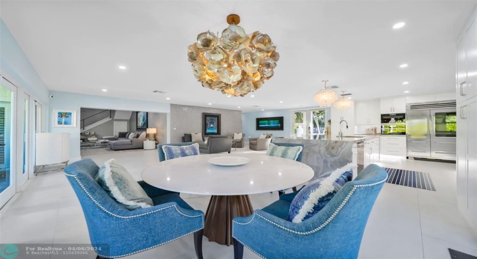 Dinning room table from view from windows towards the family room plus formal living room and kitchen to the right.