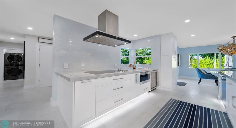 Extra deep quarts counter top, MILE cooktop & hood, Wolfe drawer micro wave and Wolfe wine cooler.