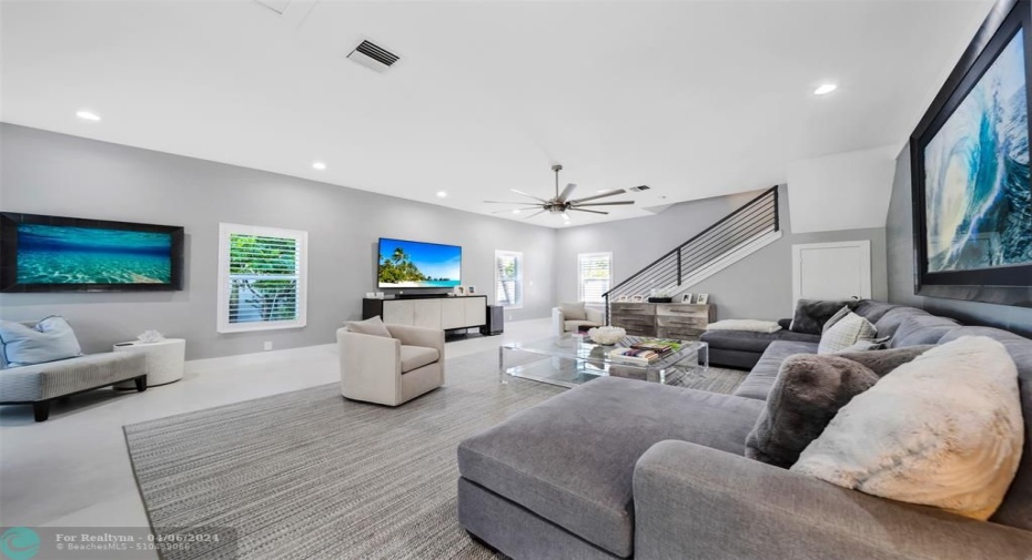 Spacious Living room with stair case to the primary master bedroom & bathroom on the second floor.