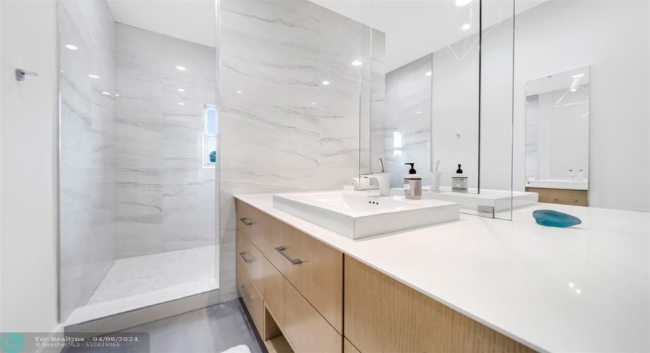 Primary en suite bathroom with double mirror & double sink and walk in shower