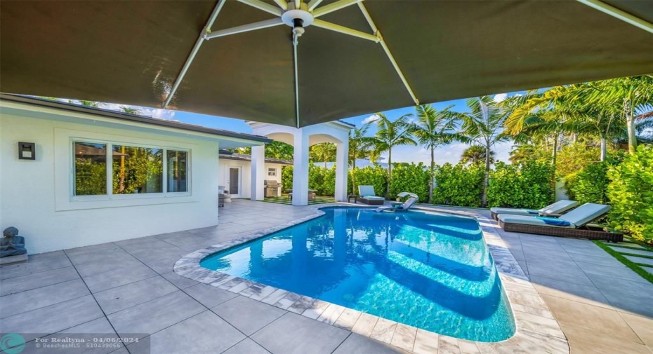 View from the outdoor sectional area towards covered dinning area and pool.