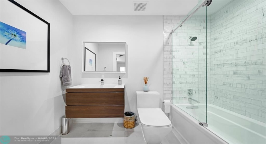 En suite bathroom to 2nd bedroom with shower tub combination.