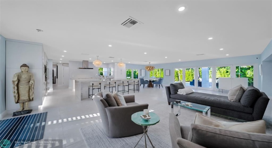 Entrance with a luxurious open front living area, amazing chef kitchen and direct views of the tropical pool & backyard.