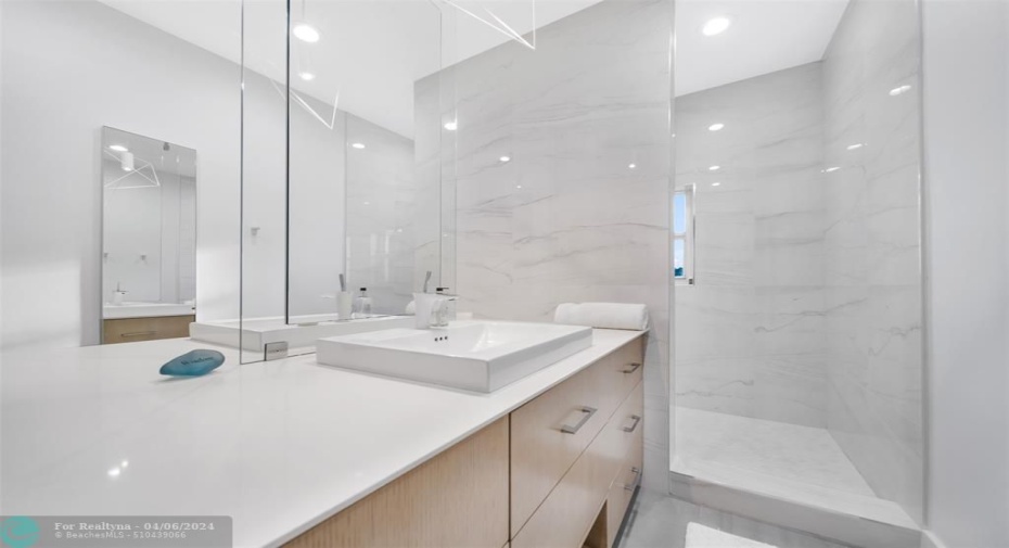 Plenty of space for two, with double mirror, double sink and double entry shower in master.